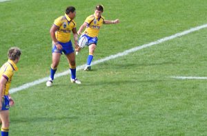 Parramatta half back Jason Seage kicking for territory while Rodney Moefaauo looks on