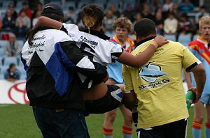 Micheal Lichaa is carried from the field after a serious knee injury - Get well mick ( Photo : Steve Montgomery / OurFootyTeam.com) 