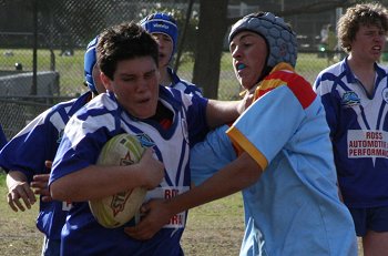 Bosco player tries to palm De La's Dion Beattie 