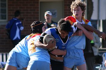 Nick & Tommy McLennan tackle Michael ( Photo : ourfooty media) 