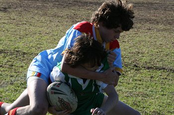 Gymea kick the ball back into play & gets his man