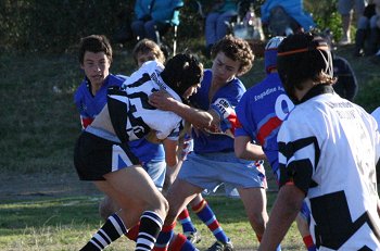 Dragons player tackles the Sharks attacker 