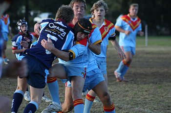 Nick Pleasence from De La Salle wraps up the Aquinas player (Photo : ourfooty media)