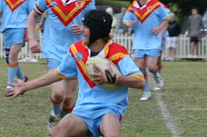 De La fullback Aaron Faulkner running sideways to adviod a Shark attack 