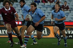 Tommy Hancock smashes his way thru the Qld Defence (Photo : ourfooty media)