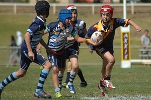 Jaden Wilson takes up the ball for St John's against Macquarie in the 2009 Under-11s Junior Rugby League grand final at Apex Oval.