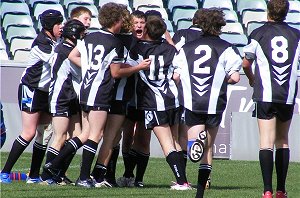 James Paton is swamped by team mates after scoring. 