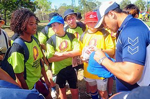 SIGNED AND SEALED . . . junior development camp participant Joe Taylor, 14, of Emerald grabs Cowboy David Faiumu's autograph during a break in proceedings at JCU yesterday