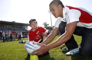 Chase Stanley has fun with the kids on Dragons Family Fun Day