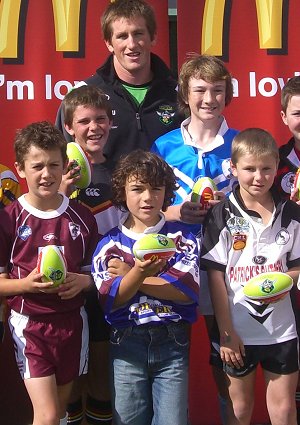 PHOTO: Raiders halfback Josh McCrone and local McDonald’s owner Craig Coleman with players from each local rugby league club in Canberra.