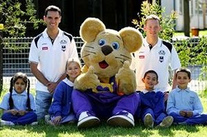 Tony De Las Haras and Brett Suttor pictured with Ditto the Bravehearts Lion and Blacktown South Public School students