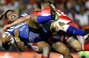 Ali Lauititi goes down under strong Tongan defence in their World Cup match at Penrith. Picture: Gregg Porteous. / The Courier-Mail