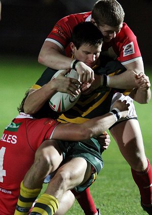 Nick O'Hara gets tackled by the Welsh d (Photo : Ian Lovell)