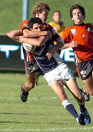 TACKLE: The Territory's Jason Gebert wraps up Victoria's Robbie Kurth. Picture: BRAD FLEET