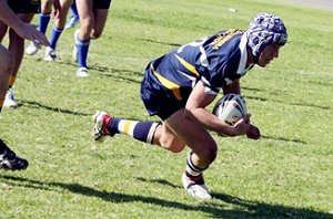 Joe Bradley crosses for one of his four tries in Monday’s University Shield match against Mount Austin High at Fisher Park.