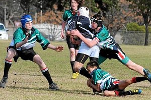 Dubbo College’s Lachlan Van Dartel and Tony Pellow (around the ankles) work together in a tackle