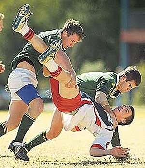 Farrer’s Jack Shelton (left) and Josh Dutton upend a Balgowlah ball-runner in yesterday’s big Uni Shield win. Photo: Barry Smith