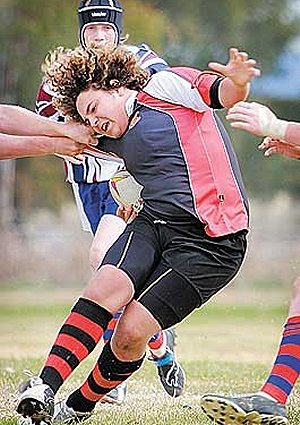 Inverell’s Martin Smith is caught uncomfortably during 15s Country Cup action yesterday. Photos: Grant Robertson