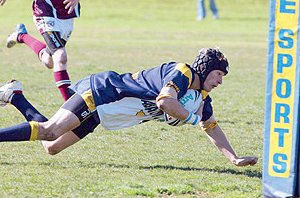 Blake Cowled dives over for the first of many tries during his team’s 34-point thumping of Blayney High School in the University Shield