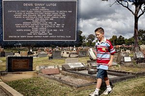 Lachlan Dwyer visits the grave of his great great grandfather Dinny Lutge, the first captain of the Kangaroos