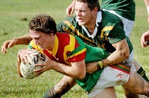 Woodlawn’s Doug Pepper scores a try for his team despite the best efforts of the Farrer defence.