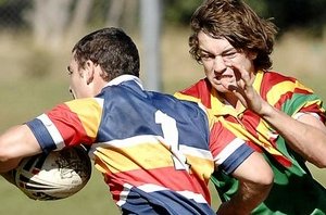 Mitchell Krause is hell-bent on stopping St Francis Xavier College’s Justin Smith in their Arrive Alive Cup rugby league game at Woodlawn yesterday. David Nielsen