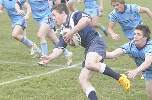 Ryan McCarthy evades a tackle from a St Gregory’s defender on a raid down the left hand side of the field. Photo: CHRIS SEABROOK