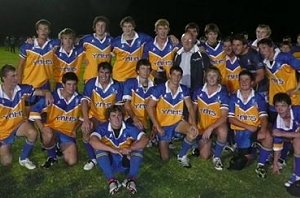 Yanco Agricultural High School’s rugby league team celebrate its Dave Sheldrick Shield win with retiring principal Colin Brown,