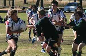 Yass High School fullback 'Buster' Connors hits a hole provided by vice-captain Judd Sherratt.