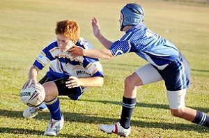 Holy Spirit's Rhys McBride on his way to the tryline as Mirani's Joel Dinsdale moves in. Jennifer Treloar